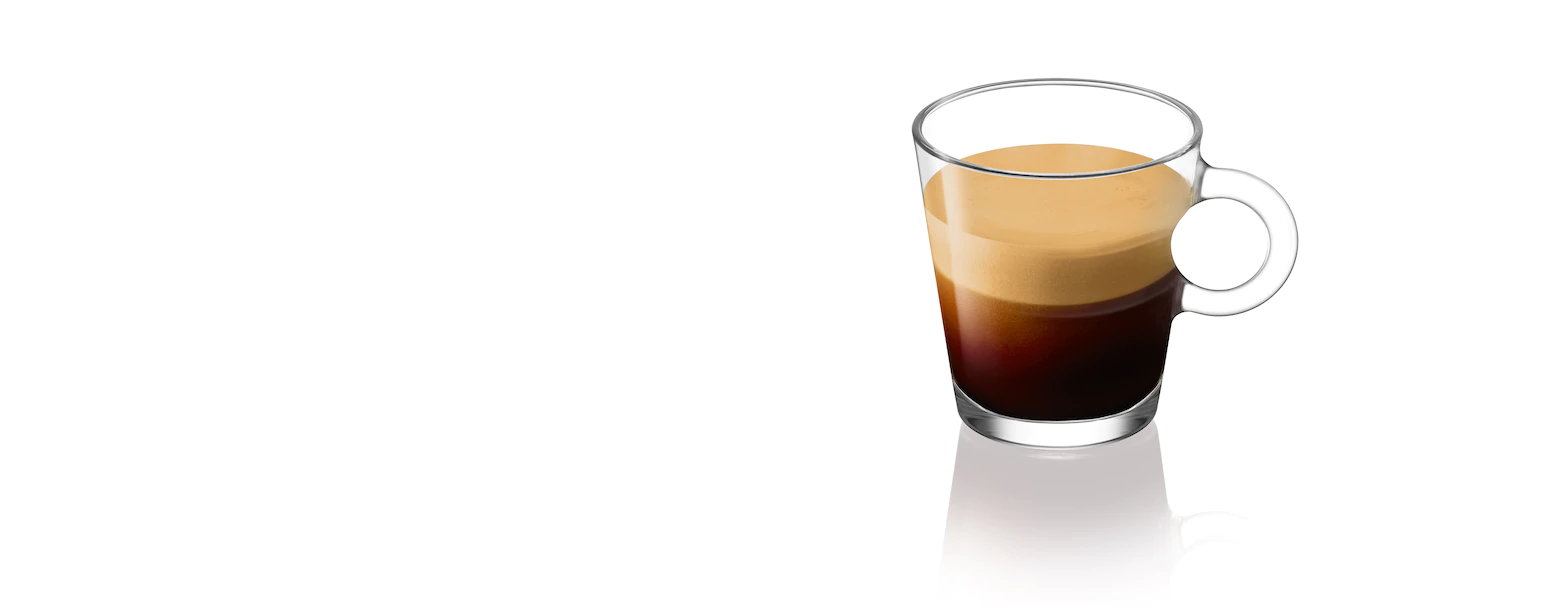 Nespresso cup of fresh made espresso lungo with empty capsule Stock Photo -  Alamy