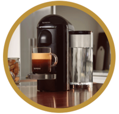Nespresso VertuoPlus Coffee Machine Ink Black in a red circle in a brown circle logo