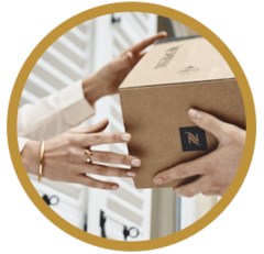 Woman receiving a Nespresso delivery box in a brown circle