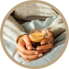 Woman holding a Nespresso Coffee in two hands