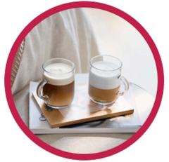 Two Cappuccinos in tqo Nespresso glasses in a red circle