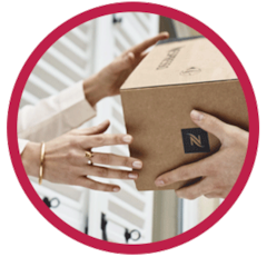 Woman receiving a Nespresso delivery box in a red circle