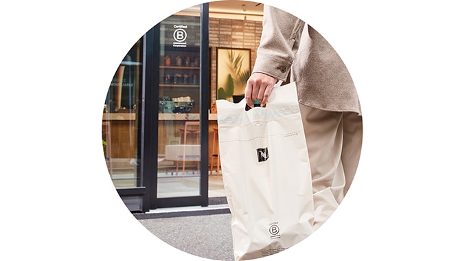Person holding a coffee pod recycling bag