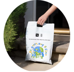 Woman holding a Nespresso Coffee in two hands