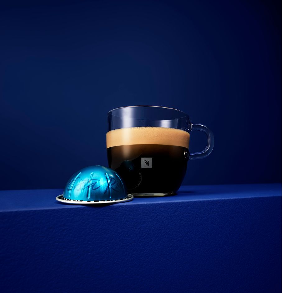 A close-up of a Costa Rica coffee cup placed on a reflective dark surface