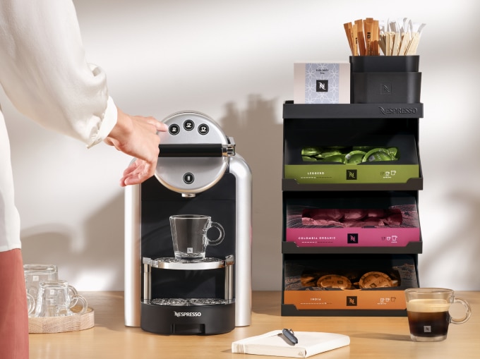 Zenius Coffee Machine with capsule dispenser on the side.
